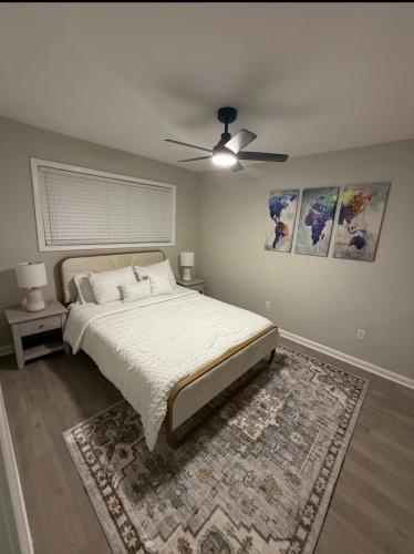 a bedroom with a bed and a ceiling fan at Uptown Modern Escape 4bd 2ba in Memphis