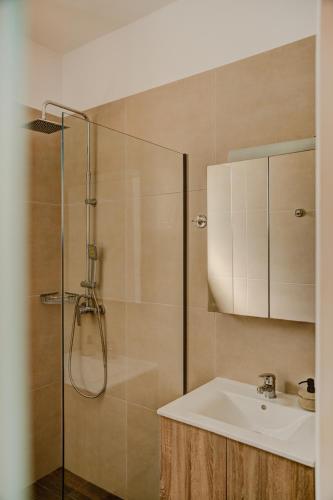 a bathroom with a sink and a shower at Indigo Seaside Experience in Adelianos Kampos