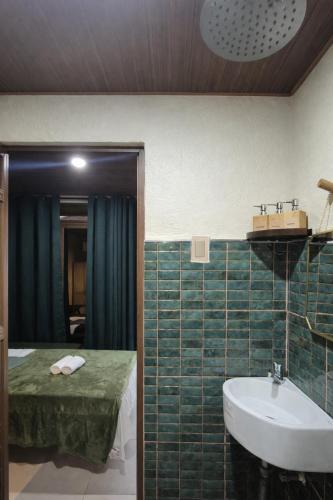 a bathroom with a sink and a bed and a tub at Casa Elia l Beach Nook Suite l Walk to Beach&Surf in San Juan