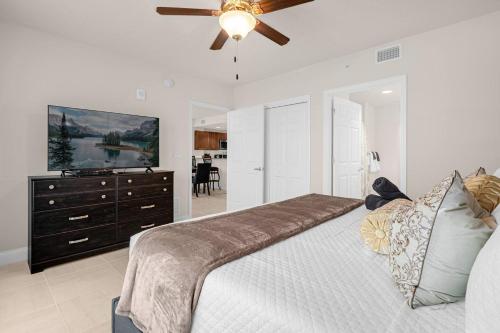 a bedroom with a large bed and a ceiling fan at Beachfront Condo with Spacious Balcony in Daytona Beach