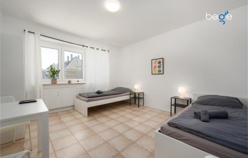 a white room with two beds and a window at BEGE APARTMENTS ProStay in Lüdenscheid
