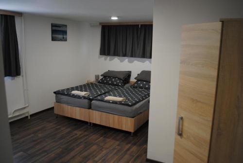 a bedroom with a bed in a room at DIÓ Vendégház in Balatonfenyves