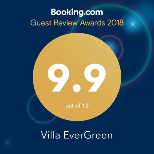 a yellow circle with the text quest review awards evergreen at Villa EverGreen near the city center with private garden, hot tub, garage parking, patio in Vilnius