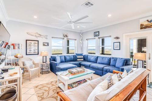 a living room with a blue couch and a table at Gulf Breezes Unit A in Port Aransas