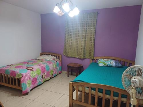a bedroom with two beds and a window at Quinta Los Guacamayos in El Picacho