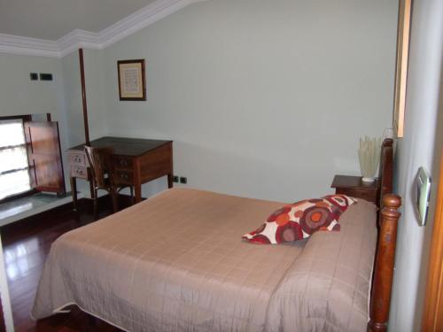 a bedroom with a bed with a table and a desk at Aititerena in Murueta-Orozko