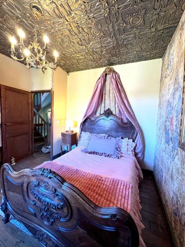 a bedroom with a canopy bed with a ceiling at Charming BB Room in Historic Saint-Martial-le-Mont, Creuse in Saint-Martial-le-Mont