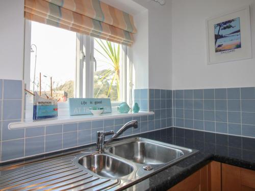 a kitchen with a sink and a window at 16 Bolt Head in Salcombe