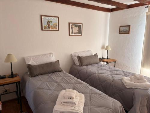 a bedroom with two beds with towels on them at Lodge Ruta 71 in Trevelín