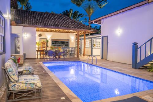 a swimming pool in the backyard of a house at Casa Poema Paraty in Paraty