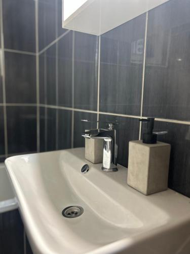 a white sink in a bathroom with a mirror at Apartman Stone Garden 2 in Mostar