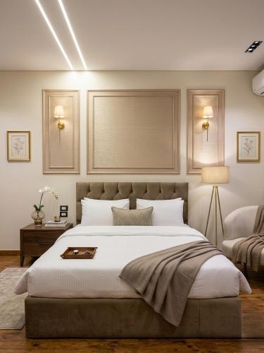 a bedroom with a large white bed and a table at New LH Cairo Hotel in Cairo