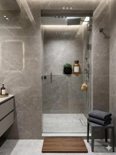 a shower with a glass door in a bathroom at New LH Cairo Hotel in Cairo