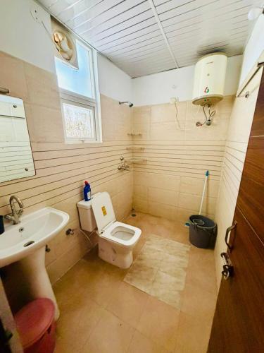 a bathroom with a toilet and a sink at Pradise in Mohali