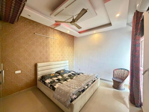 a bedroom with a bed and a ceiling fan at Pradise in Mohali