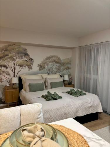 a hotel room with two beds with towels on them at HelloWine Apartman II in Eger