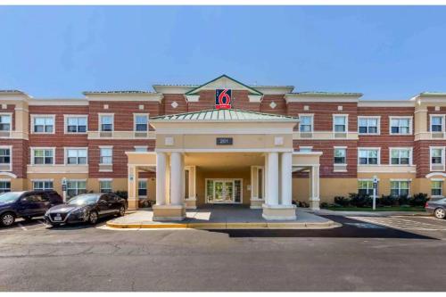 a large building with a gazebo in front of it at Studio 6 Extended Stay Washington - DC Gaithersburg South MD in Gaithersburg