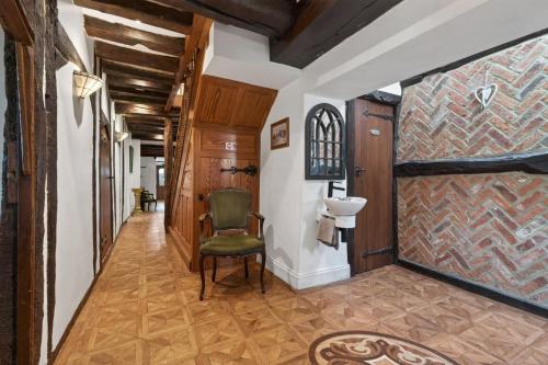 a hallway in a house with a chair and a wall at 9 Bed in Alkham oc-m34784 in Swingfield