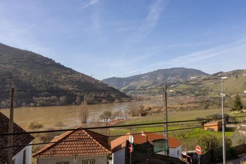 a view of a village with mountains in the background at Casa Estação Douro Vista in Vila Marim