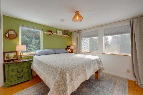a bedroom with a bed and two windows at Bring Your Pets! Secluded Homer Escape w/ Deck in Homer