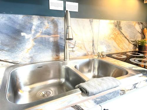 a stainless steel kitchen sink with a towel on it at Casa Conchalito in La Paz