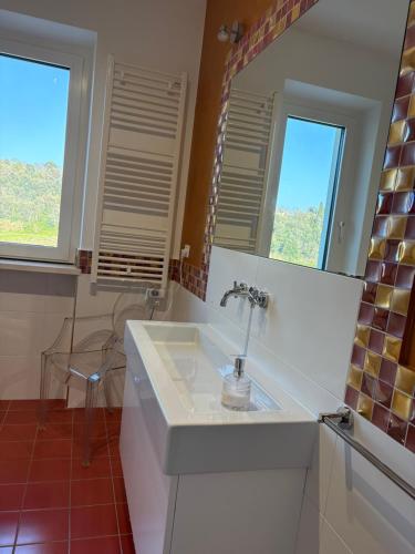 a bathroom with a sink and a mirror at B&B Azzurra in Pescara