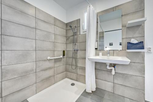 a bathroom with a sink and a shower at Logis Hôtel La Bastide d'Entraigues in Entraigues-sur-la-Sorgue