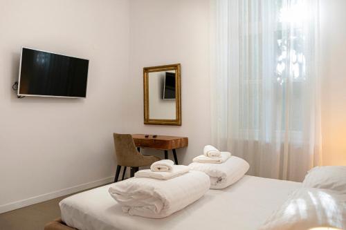 a bedroom with two beds and a table and a mirror at Luksuzni apartmaji v centru Portoroža z vrtom in parkiriščem - Luxury Apartments in Portoroz Center with Garden & Parking in Portorož