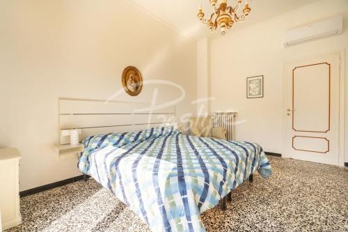 a bedroom with a bed and a chandelier at Villa Elena in Portovenere