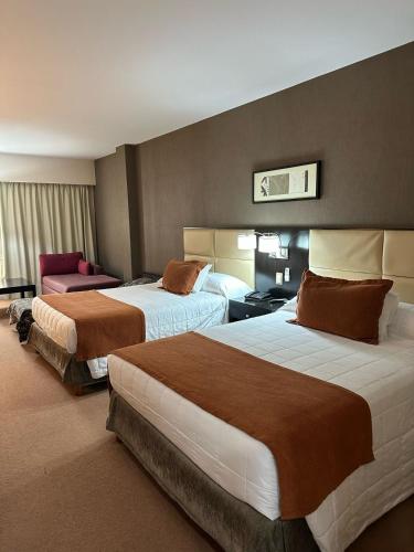 a hotel room with two beds in a room at Howard Johnson Hotel & Casino in Formosa