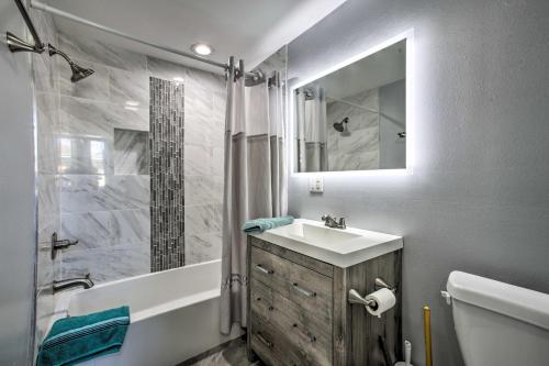 a bathroom with a tub and a sink and a shower at 5 Mi to French Quarter NOLA Getaway with Patio! in New Orleans