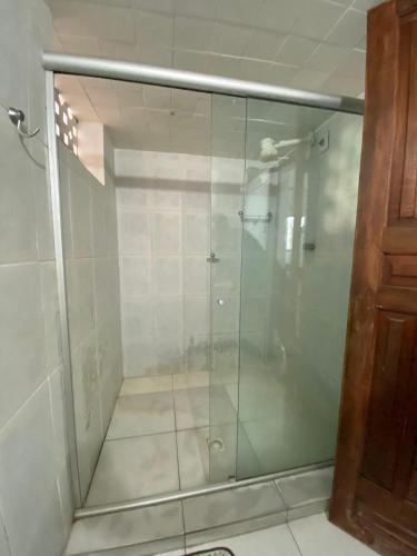 a glass shower stall in a bathroom with at Pé na Villa in Itacaré