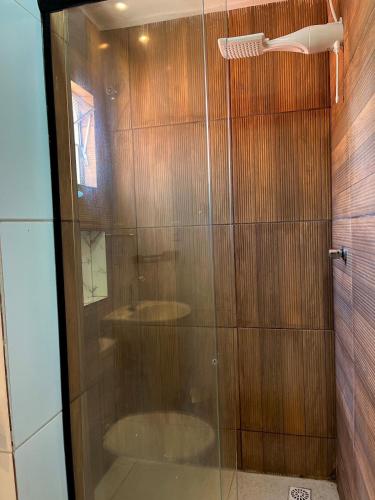 a shower with a glass door in a bathroom at Apto Master a 30m da Praça da Sé - Norões Residence in Crato