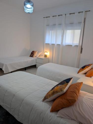 a bedroom with two beds with pillows on them at Cozy rooms in Minde, Fatima in Minde