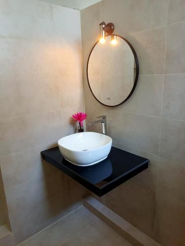 a bathroom with a sink and a mirror on a counter at Jasmin Garden in Kalutara