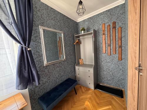 a room with a wall with a mirror and hockey equipment at Bérc Apartman in Egerszalók