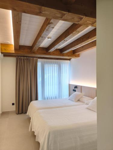 two beds in a bedroom with a window at Casa Rural ASTEI in Muxika