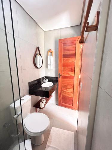 a bathroom with a toilet and a sink at Môzzi Barra Grande in Barra Grande