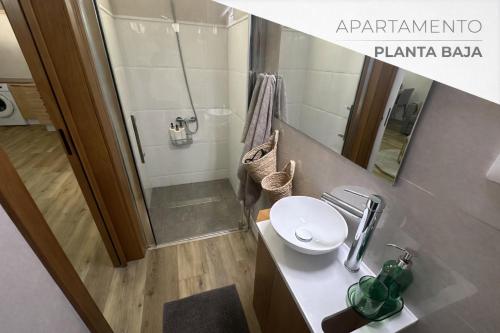 a bathroom with a shower and a white sink at Rayo Verde-Vistas al mar in Punta del Hidalgo