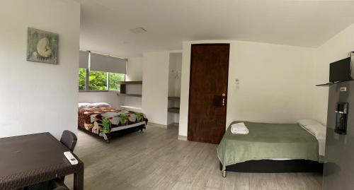 a hotel room with two beds and a desk at Casona La Carolina in San Andrés