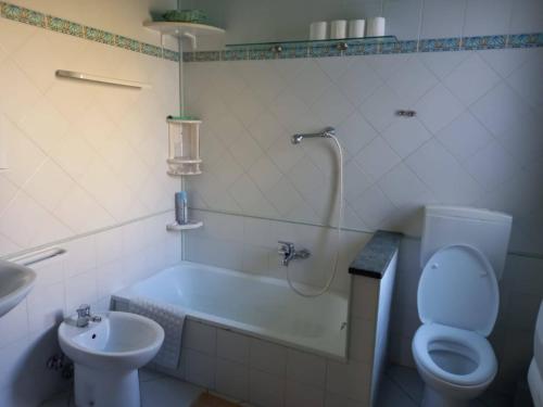 a bathroom with a tub and a toilet and a sink at Casa Vallati in Scardovari