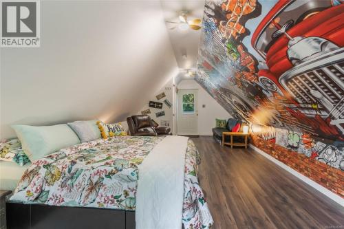 a bedroom with a bed and a wall mural at Nesting Ravens cottage in Nanaimo