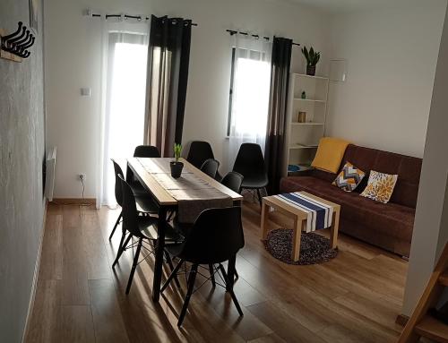 a living room with a table and chairs and a couch at Noclegi u Nikoli in Wola Wereszczyńska