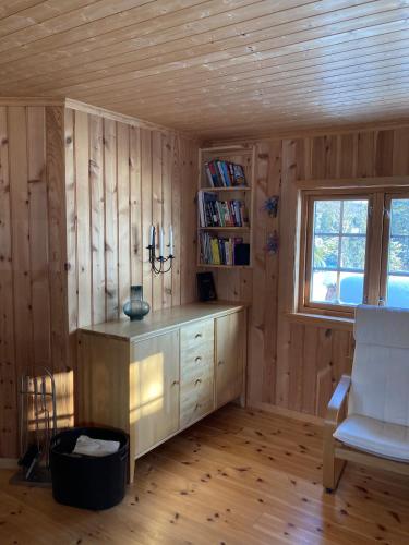 a room with wooden walls and a desk and a window at Cabin in Tydal, enjoy! in Tydal