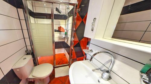 a bathroom with a shower and a toilet and a sink at Villa Summer House in Saints Constantine and Helena