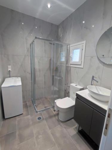 a bathroom with a shower and a toilet and a sink at VILLA HAWAii in Nea Moudania