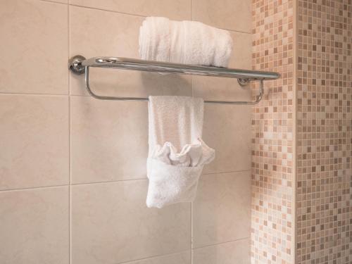 a bathroom with white towels on a towel rack at La Maison du Coeur in Bari