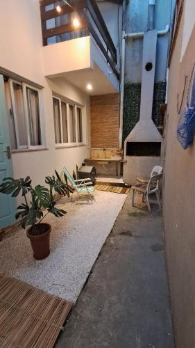 a room with chairs and a table in a building at Casa Vila Mar Guesthouse in Guaratuba