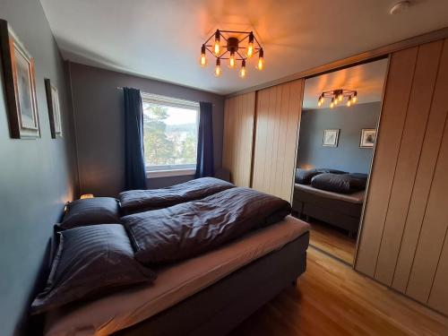 a bed in a bedroom with a window and a bed sidx sidx sidx at Apartment with a view at Tonsenhagen in Oslo