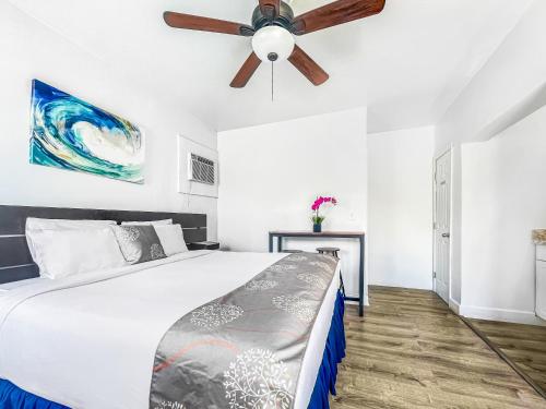 a bedroom with a bed and a ceiling fan at The Oasis in Hollywood